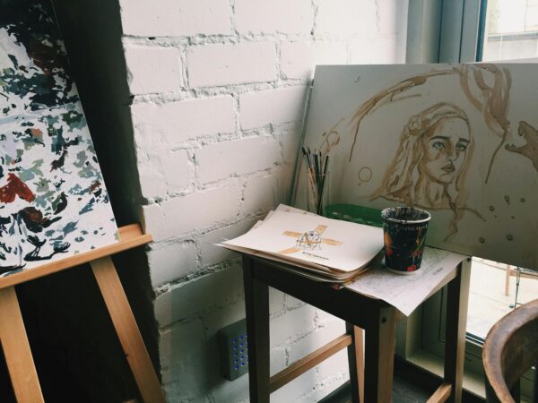 Creative artist workplace with drawings on easel